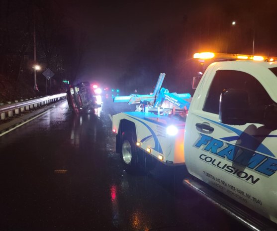 Tow truck assisting with accident recovery on Long Island from Frame Auto Collision