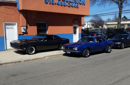 Classic cars parked outside Frame Auto Collision auto body shop in Nassau County NY