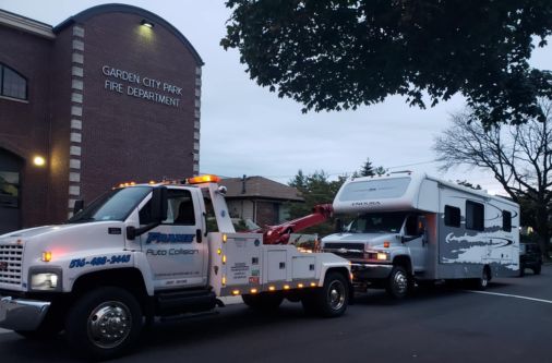 Frame Auto Collision tow truck pulling an RV on Long Island NY